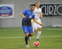 Players kicking soccer ball