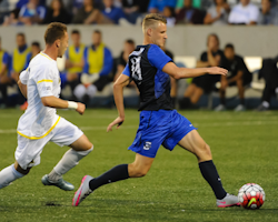 Players kicking soccer ball
